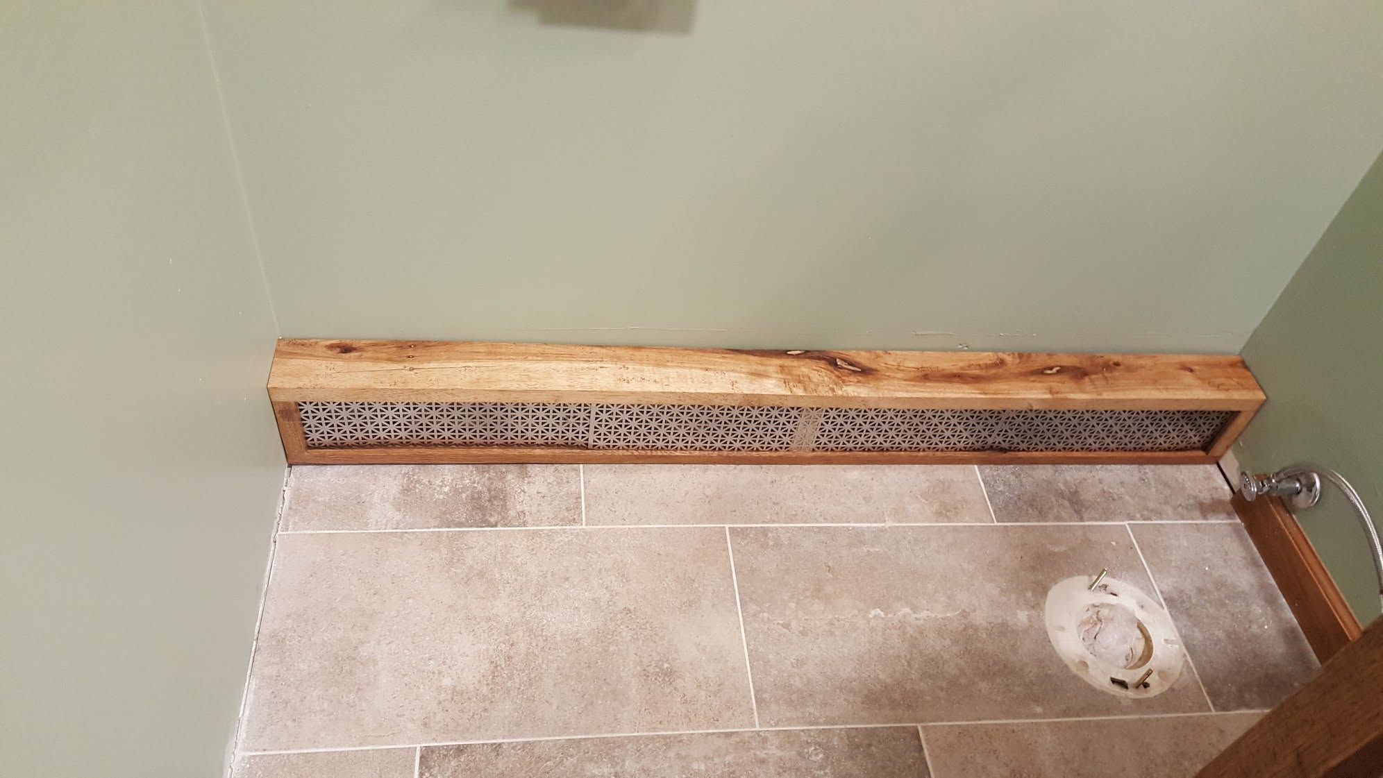 Custom hardwood floor grate cover finished flush with the surrounding flooring