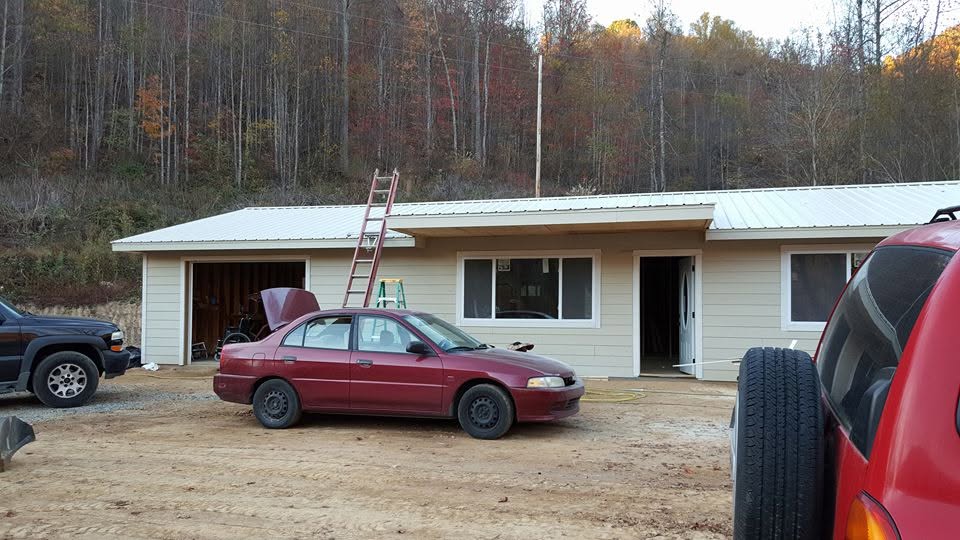 Metal roof installation on a rural East Tennessee home with fall foliage