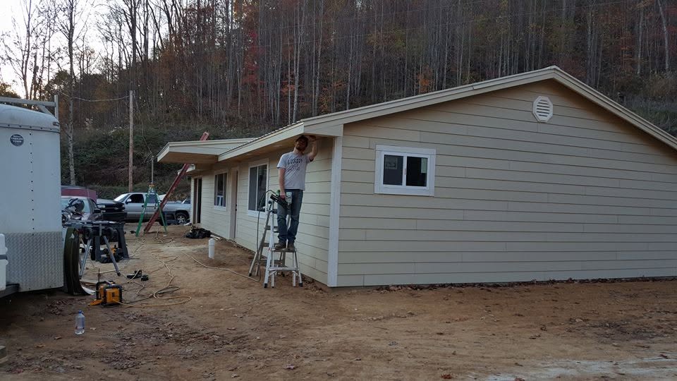 Fiber-cement siding installation on a new build with crew at work