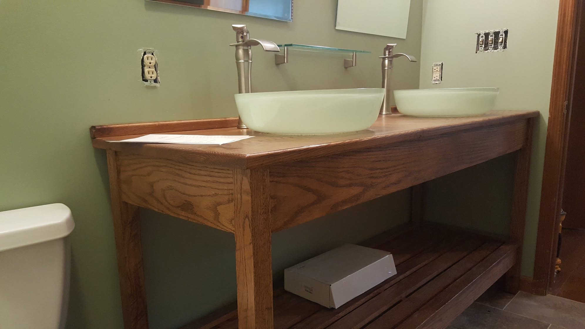 Custom oak double vanity with vessel sinks and brushed nickel fixtures